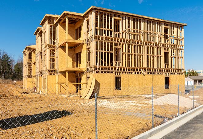 a temporary chain link fence in front of a building under construction, ensuring public safety in Runnemede, NJ